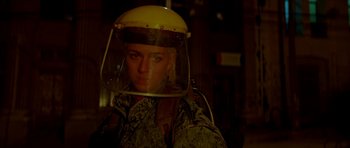 Movie still from “Ema” (2019), directed by Pablo Larraín – A woman wearing a helmet is standing in the dark; Close Up shot, Over the shoulder angle