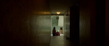 Movie still from “Ema” (2019), directed by Pablo Larraín – Two people sitting on the floor of a building; Extreme Wide shot, Low angle