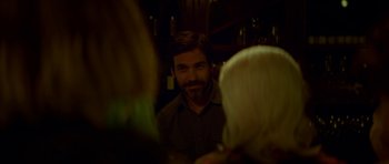 Movie still from “Ema” (2019), directed by Pablo Larraín – A man with a goatee is looking at a woman with blonde hair; Close Up shot, Over the shoulder angle