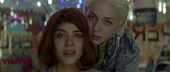 Movie still from “Ema” (2019), directed by Pablo Larraín – Two young women posing for a picture in a room; Close Up shot, Low angle
