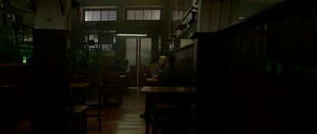 Movie still from “Ema” (2019), directed by Pablo Larraín – Two people sitting at a table in a restaurant; Wide shot, Over the shoulder angle
