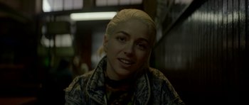 Movie still from “Ema” (2019), directed by Pablo Larraín – A person with blonde hair; Close Up shot, Over the shoulder angle