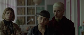 Movie still from “Ema” (2019), directed by Pablo Larraín – A woman with short hair is standing next to another woman with short hair; Close Up shot, Low angle