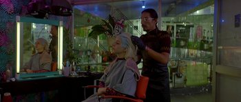 Movie still from “Ema” (2019), directed by Pablo Larraín – A woman getting her hair done by a stylist; Medium shot, Over the shoulder angle