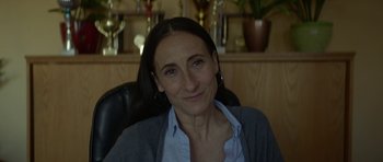 Movie still from “Ema” (2019), directed by Pablo Larraín – A person sitting in a chair; Close Up shot, Over the shoulder angle