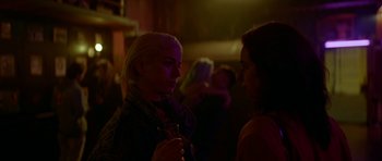 Movie still from “Ema” (2019), directed by Pablo Larraín – Two women standing in a room talking to each other; Close Up shot, Over the shoulder angle