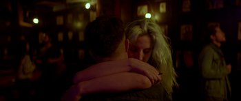 Movie still from “Ema” (2019), directed by Pablo Larraín – A man and a woman hugging each other in a dark room; Close Up shot, Low angle