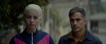 Movie still from “Ema” (2019), directed by Pablo Larraín – A man and a woman standing next to each other on the street; Close Up shot, Over the shoulder angle