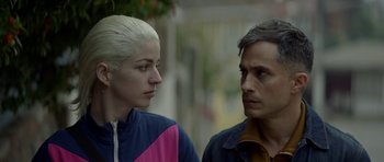 Movie still from “Ema” (2019), directed by Pablo Larraín – A man and a woman standing next to each other; Close Up shot, Over the shoulder angle