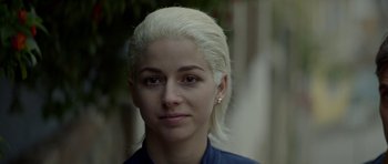 Movie still from “Ema” (2019), directed by Pablo Larraín – A person with white hair; Close Up shot, Over the shoulder angle