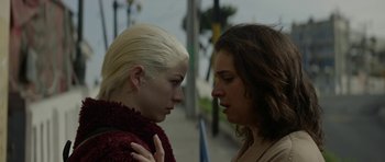 Movie still from “Ema” (2019), directed by Pablo Larraín – Two women face each other on the sidewalk; Close Up shot, Low angle