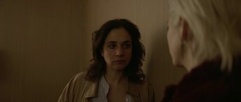 Movie still from “Ema” (2019), directed by Pablo Larraín – A woman looking at herself in the mirror; Close Up shot, Over the shoulder angle