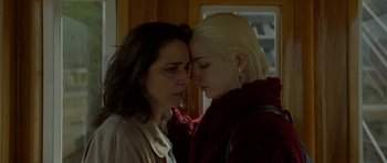 Movie still from “Ema” (2019), directed by Pablo Larraín – Two women standing next to each other in front of a window; Close Up shot, Over the shoulder angle