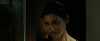 Movie still from “Encounter” (2021), directed by Michael Pearce – A woman's face in the dark; Close Up shot, Over the shoulder angle