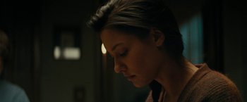 Movie still from “Encounter” (2021), directed by Michael Pearce – A person with her head down; Close Up shot, Over the shoulder angle