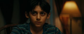 Movie still from “Encounter” (2021), directed by Michael Pearce – A young boy is staring straight ahead; Close Up shot, High angle