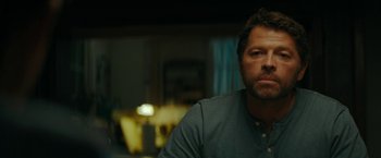 Movie still from “Encounter” (2021), directed by Michael Pearce – A person sitting in a room; Close Up shot, Over the shoulder angle