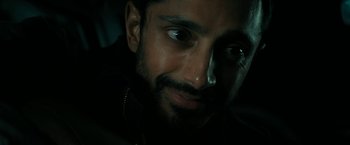 Movie still from “Encounter” (2021), directed by Michael Pearce – A person with a beard and nose ring; Close Up shot, Over the shoulder angle