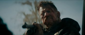 Movie still from “Encounter” (2021), directed by Michael Pearce – A person holding a gun; Close Up shot, Low angle