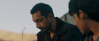Movie still from “Encounter” (2021), directed by Michael Pearce – A person wearing a jacket; Close Up shot, Over the shoulder angle
