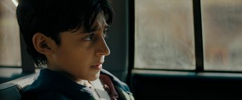 Movie still from “Encounter” (2021), directed by Michael Pearce – A young boy sitting in a car looking out the window; Close Up shot, Low angle