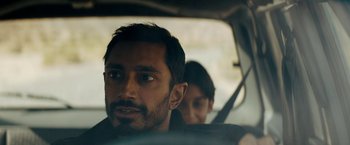 Movie still from “Encounter” (2021), directed by Michael Pearce – A man and a woman sitting in a car looking out the window; Close Up shot, Over the shoulder angle