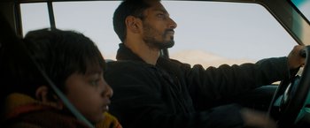 Movie still from “Encounter” (2021), directed by Michael Pearce – A man sitting in a car next to a little girl; Close Up shot, Over the shoulder angle