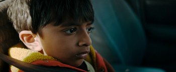 Movie still from “Encounter” (2021), directed by Michael Pearce – A child's face looking at the camera; Close Up shot, Low angle
