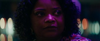 Movie still from “Encounter” (2021), directed by Michael Pearce – A woman's face in the dark; Close Up shot, Over the shoulder angle