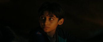 Movie still from “Encounter” (2021), directed by Michael Pearce – A young boy is looking up at the sky; Close Up shot, High angle