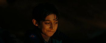 Movie still from “Encounter” (2021), directed by Michael Pearce – A young boy is looking up in the dark; Close Up shot, High angle