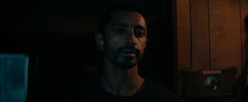 Movie still from “Encounter” (2021), directed by Michael Pearce – A person wearing a black t - shirt; Close Up shot, Low angle