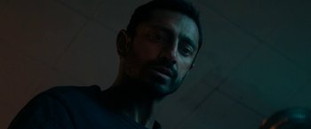 Movie still from “Encounter” (2021), directed by Michael Pearce – A person wearing a black shirt; Close Up shot, Low angle