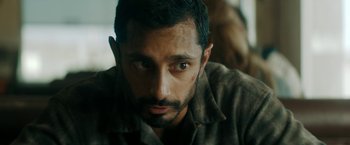 Movie still from “Encounter” (2021), directed by Michael Pearce – A person wearing a shirt; Close Up shot, Over the shoulder angle