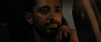 Movie still from “Encounter” (2021), directed by Michael Pearce – A person talking on a cell phone; Close Up shot, Low angle