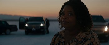 Movie still from “Encounter” (2021), directed by Michael Pearce – A woman standing in front of a car on a road; Close Up shot, Over the shoulder angle