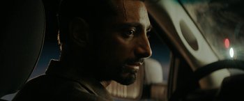 Movie still from “Encounter” (2021), directed by Michael Pearce – A man's face in a car; Close Up shot, Over the shoulder angle