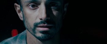 Movie still from “Encounter” (2021), directed by Michael Pearce – A person with a beard; Extreme Close Up shot, Overhead angle