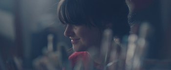 Movie still from “Endings, Beginnings” (2019), directed by Drake Doremus – A woman's face in the dark; Close Up shot, Over the shoulder angle