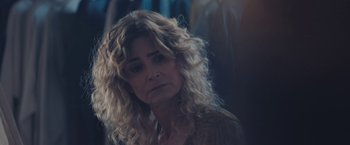 Movie still from “Endings, Beginnings” (2019), directed by Drake Doremus – A person with curly blonde hair; Close Up shot, Over the shoulder angle