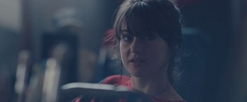 Movie still from “Endings, Beginnings” (2019), directed by Drake Doremus – A person in a car on a city street; Close Up shot, Over the shoulder angle