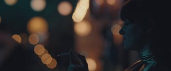 Movie still from “Endings, Beginnings” (2019), directed by Drake Doremus – A person holding a cigarette in their hand; Extreme Close Up shot, Over the shoulder angle