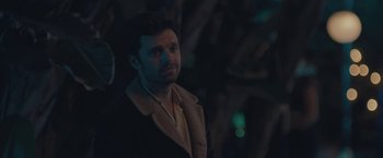 Movie still from “Endings, Beginnings” (2019), directed by Drake Doremus – A man standing in the dark wearing a coat; Close Up shot, Over the shoulder angle