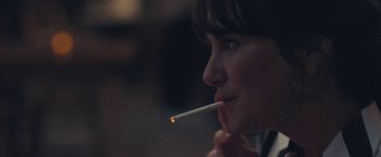 Movie still from “Endings, Beginnings” (2019), directed by Drake Doremus – A woman is smoking a cigarette at night; Extreme Close Up shot, Over the shoulder angle
