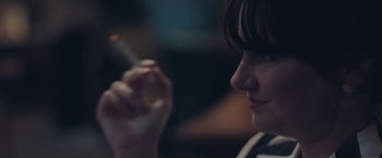 Movie still from “Endings, Beginnings” (2019), directed by Drake Doremus – A woman is holding a cigarette in her hand; Close Up shot, Over the shoulder angle
