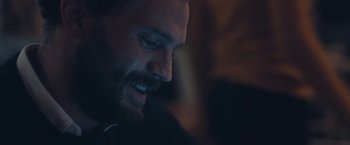 Movie still from “Endings, Beginnings” (2019), directed by Drake Doremus – A bearded man's face in a dark room; Close Up shot, Over the shoulder angle