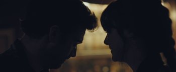 Movie still from “Endings, Beginnings” (2019), directed by Drake Doremus – A man and a woman face to face in the dark; Extreme Close Up shot, Over the shoulder angle
