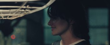 Movie still from “Endings, Beginnings” (2019), directed by Drake Doremus – A woman's face in the dark; Close Up shot, Over the shoulder angle