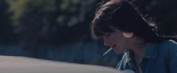 Movie still from “Endings, Beginnings” (2019), directed by Drake Doremus – A woman smoking a cigarette while sitting in a car; Extreme Close Up shot, Over the shoulder angle