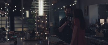 Movie still from “Endings, Beginnings” (2019), directed by Drake Doremus – A man and a woman drinking wine in a kitchen; Medium shot, Over the shoulder angle